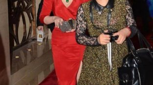65岁刘晓庆还是那么时尚，配合大红SE的裙子，露出自己的事业线